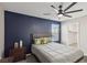 Stylish bedroom features an accent wall, ceiling fan, and natural light from the window at 10933 Sageview Ave, Las Vegas, NV 89166