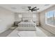 Spacious bedroom with a ceiling fan, carpeted floor, and multiple windows at 10933 Sageview Ave, Las Vegas, NV 89166