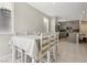 Open dining area with white tile flooring and view into the kitchen at 10933 Sageview Ave, Las Vegas, NV 89166