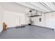 Spacious garage with gray epoxy flooring, overhead storage rack, and side entry door at 10933 Sageview Ave, Las Vegas, NV 89166