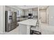 Modern kitchen with stainless steel appliances and a breakfast bar at 10933 Sageview Ave, Las Vegas, NV 89166