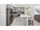 Well-lit kitchen featuring an island with bar stools and stainless appliances at 10933 Sageview Ave, Las Vegas, NV 89166