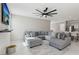 Bright living room with tile floors, large fan, and comfortable gray sectional sofa at 10933 Sageview Ave, Las Vegas, NV 89166