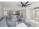 Open-concept living room with tile floors and view into the kitchen with stainless appliances at 10933 Sageview Ave, Las Vegas, NV 89166