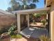 Inviting backyard featuring a covered patio, lush greenery, and decorative pots at 1472 Creslow Ct # 101, Las Vegas, NV 89102