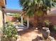 Charming backyard with mature palm tree, patio cover, landscaping, and decorative pots at 1472 Creslow Ct # 101, Las Vegas, NV 89102