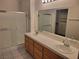 Well-lit bathroom features a double sink vanity, walk-in closet, and a shower with a sliding glass door at 1472 Creslow Ct # 101, Las Vegas, NV 89102
