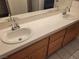 Bathroom vanity features a double sink, sleek chrome faucets and wood finish cabinets at 1472 Creslow Ct # 101, Las Vegas, NV 89102