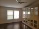Bedroom featuring wood floors, a closet with mirrors, and a ceiling fan at 1472 Creslow Ct # 101, Las Vegas, NV 89102