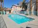 Sparkling community pool with clear blue water, surrounded by lounge chairs at 1472 Creslow Ct # 101, Las Vegas, NV 89102