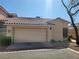 Attached two-car garage with a well-maintained driveway and desert landscaping at 1472 Creslow Ct # 101, Las Vegas, NV 89102