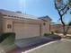 Attached two-car garage with a well-maintained driveway and desert landscaping at 1472 Creslow Ct # 101, Las Vegas, NV 89102