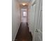 Hallway with wood floors leading to a living area, complemented by white doors and trim at 1472 Creslow Ct # 101, Las Vegas, NV 89102