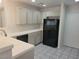 Neutral tone kitchen featuring new countertops, tile flooring, and stainless steel appliances at 1472 Creslow Ct # 101, Las Vegas, NV 89102