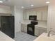 Modern kitchen featuring tile flooring, sleek countertops, and stainless steel appliances at 1472 Creslow Ct # 101, Las Vegas, NV 89102