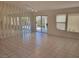Spacious living room featuring tile floors, mirrored wall, and sliding glass doors at 1472 Creslow Ct # 101, Las Vegas, NV 89102