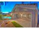 Covered patio provides view of the pool, backyard, and desert landscaping at 1563 Cattle Ranch Pl, Henderson, NV 89002