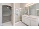 Bright bathroom featuring a shower with glass doors and a white vanity at 1563 Cattle Ranch Pl, Henderson, NV 89002
