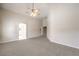 Bedroom featuring plush carpet, arched doorway, and a ceiling fan for added comfort at 1563 Cattle Ranch Pl, Henderson, NV 89002
