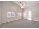 Bedroom featuring plush carpet, windows with plantation shutters, and a ceiling fan for added comfort at 1563 Cattle Ranch Pl, Henderson, NV 89002