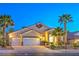 Attractive single-story home with a three-car garage, desert landscaping, and inviting front entrance at 1563 Cattle Ranch Pl, Henderson, NV 89002