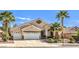 Inviting single-story home featuring a three-car garage, desert landscaping, and charming curb appeal at 1563 Cattle Ranch Pl, Henderson, NV 89002