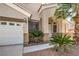 Charming home featuring desert landscaping with a three-car garage and covered front entry at 1563 Cattle Ranch Pl, Henderson, NV 89002