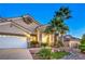 Beautiful single-story home with a three-car garage, desert landscaping, and an inviting entrance at 1563 Cattle Ranch Pl, Henderson, NV 89002