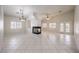 Bright, expansive living room with tile floors, modern fireplace, and multiple windows for natural light at 1563 Cattle Ranch Pl, Henderson, NV 89002