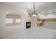 Open-concept living area with a fireplace, tile flooring, and a view of the adjacent kitchen at 1563 Cattle Ranch Pl, Henderson, NV 89002