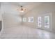 Bright living room with tile flooring, plantation shutters, ceiling fan, and access to the backyard patio through French doors at 1563 Cattle Ranch Pl, Henderson, NV 89002