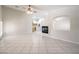 Spacious living room showcasing tile flooring, a fireplace, and an open layout leading to the kitchen, ideal for entertaining at 1563 Cattle Ranch Pl, Henderson, NV 89002