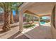 Spacious covered patio area with views of the backyard pool and landscaped surroundings at 1563 Cattle Ranch Pl, Henderson, NV 89002