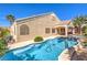 Private backyard featuring a sparkling pool and spa, surrounded by a landscaped patio area at 1563 Cattle Ranch Pl, Henderson, NV 89002