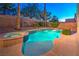 Inviting backyard pool and spa area, surrounded by lush desert landscaping and privacy walls at 1563 Cattle Ranch Pl, Henderson, NV 89002