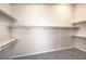Spacious walk-in closet featuring carpeted floors, shelving, and ample storage space at 1563 Cattle Ranch Pl, Henderson, NV 89002