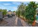 A charming backyard with a dining area in a glass enclosure, and a privacy row of trees at 197 Ebb Tide Cir, Las Vegas, NV 89123