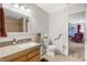Neutral bathroom with a single sink vanity, and a shower in the background at 197 Ebb Tide Cir, Las Vegas, NV 89123
