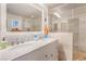 Bright bathroom with a double sink vanity and a large walk-in shower with tile surround and glass door at 197 Ebb Tide Cir, Las Vegas, NV 89123