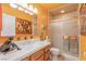 Bright bathroom features an orange accent wall, framed artwork, and stylish decor at 197 Ebb Tide Cir, Las Vegas, NV 89123