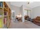 Inviting room featuring bookshelves, seating area with table, closet, carpet and plants at 197 Ebb Tide Cir, Las Vegas, NV 89123
