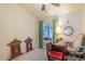 Well lit bedroom featuring a large window with green curtains, a fan, and desk at 197 Ebb Tide Cir, Las Vegas, NV 89123