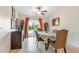 Bright dining room with tile floor, colorful tablecloth and sliding doors to the backyard at 197 Ebb Tide Cir, Las Vegas, NV 89123