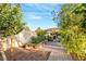 Backyard garden featuring charming landscaping, mature trees, and a winding stone path at 197 Ebb Tide Cir, Las Vegas, NV 89123