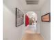 Hallway showcasing tiled and carpeted flooring and multiple framed paintings at 197 Ebb Tide Cir, Las Vegas, NV 89123