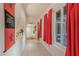 Bright hallway with tile flooring and decorative red curtains near a window at 197 Ebb Tide Cir, Las Vegas, NV 89123