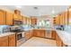 Bright kitchen featuring wooden cabinets, stainless steel appliances, and tile backsplash at 197 Ebb Tide Cir, Las Vegas, NV 89123
