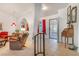 Inviting living room featuring arches, a staircase and views of the covered patio through the front door at 197 Ebb Tide Cir, Las Vegas, NV 89123