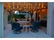 Cozy covered patio featuring lounge seating, string lights, and privacy curtains at 197 Ebb Tide Cir, Las Vegas, NV 89123