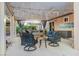 Cozy covered patio with seating, ceiling fan, string lights, and view of lush greenery at 197 Ebb Tide Cir, Las Vegas, NV 89123